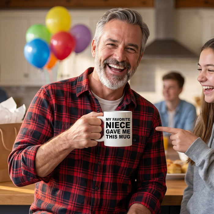 An uncle laughing as he holds his My Favorite Niece Gave Me This Mug while his teen niece points at it at a family birthday