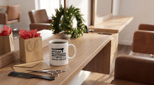 Christmas gifts for hair stylist: Miracle Worker coffee mug on a salon station with a gift bag, envelope, shears and a wreath