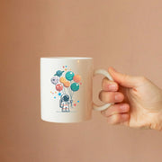 Astronaut Holding Planet Balloons Ceramic Mug 11 oz White - Panvola